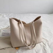 Large cream PU leather tote bag with a structured silhouette, open top, textured finish, and long double shoulder straps.