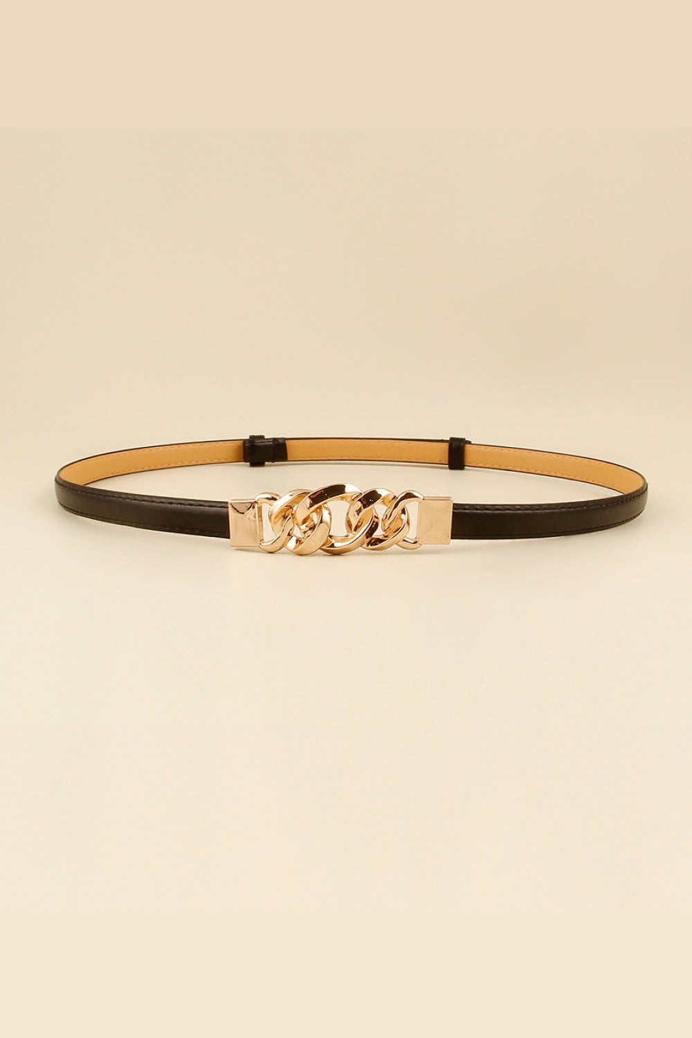 Slim black PU belt with a polished zinc alloy buckle featuring a sculptural chain-link detail and streamlined silhouette.
