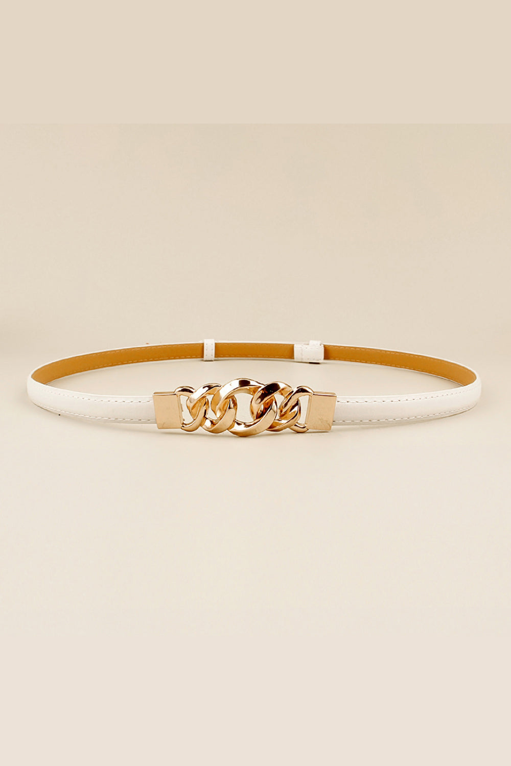 White skinny PU belt featuring stitched edges, a streamlined strap, and a sculptural gold-tone zinc alloy chain-link buckle at the center.