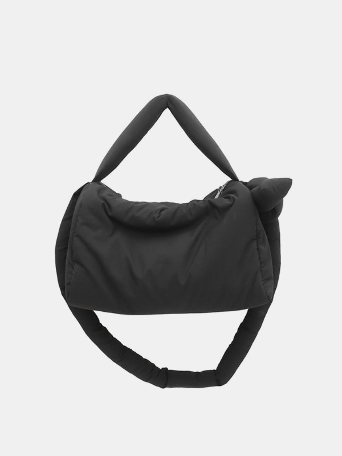 A black puffy nylon medium crossbody bag features a softly rounded silhouette, gathered padded construction, short top handle, and long padded strap.