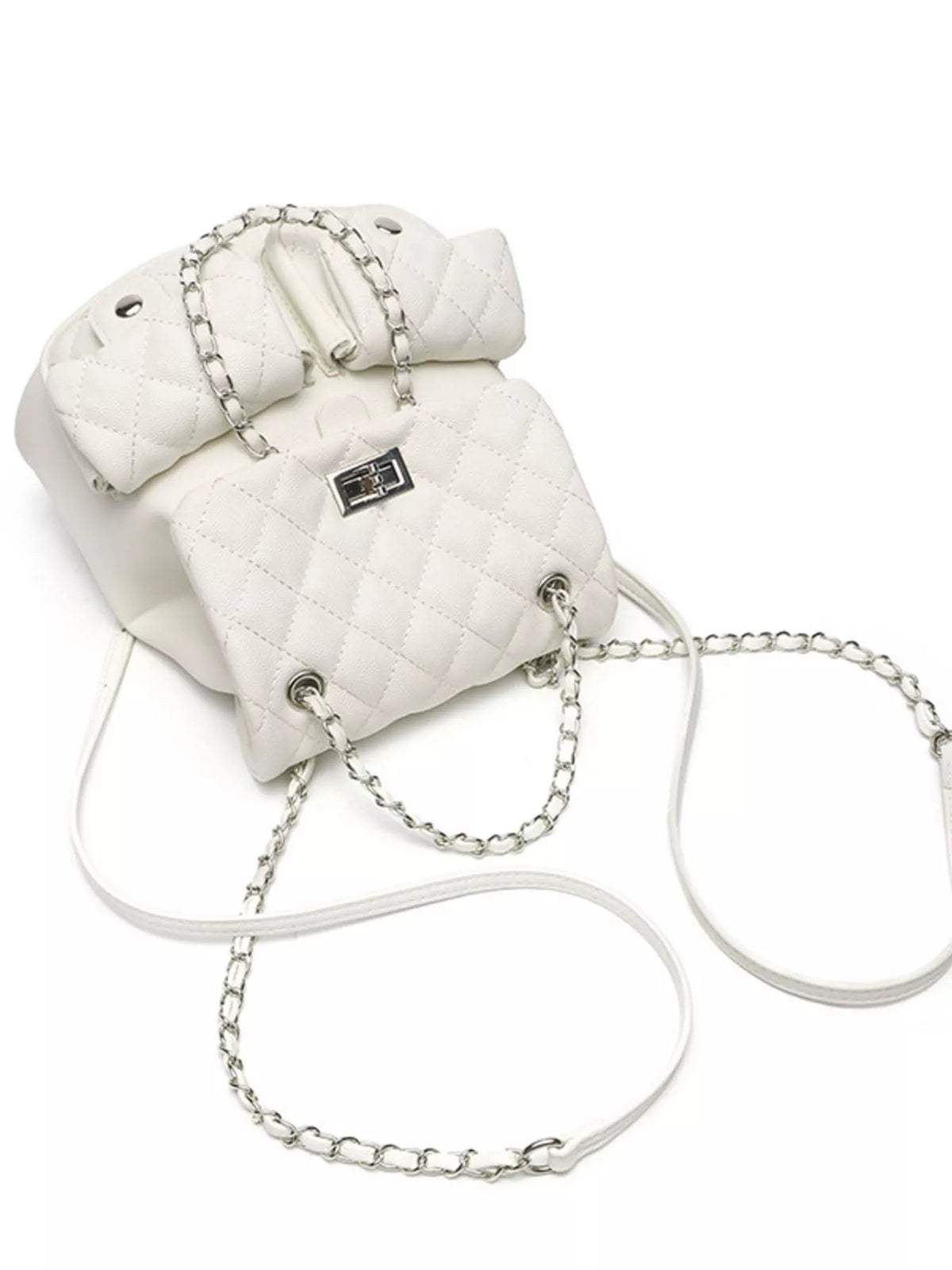 Small white quilted PU leather backpack bag featuring a flap closure, silver turn-lock hardware, and interwoven chain straps with adjustable shoulder straps.