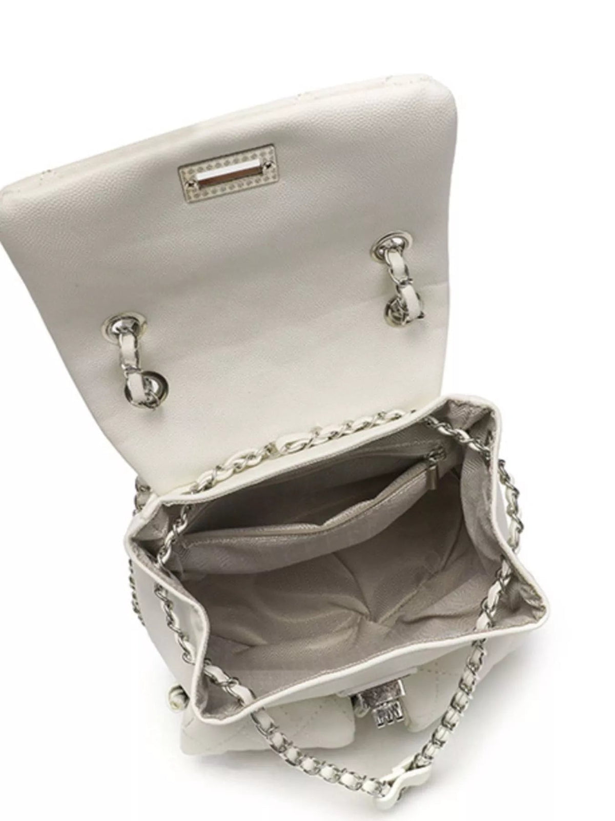 Small cream PU leather quilted chain strap backpack bag shown open, revealing a structured interior, zip pocket, flap closure, and silver-tone hardware.