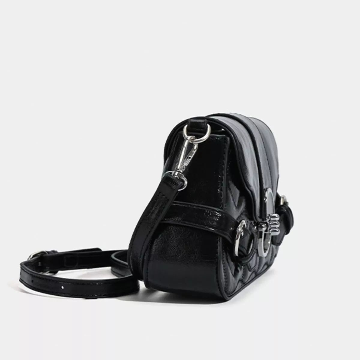 Small black PU leather crossbody bag with a structured silhouette, quilted side panels, flap closure, buckle-style hardware, and a detachable shoulder strap.