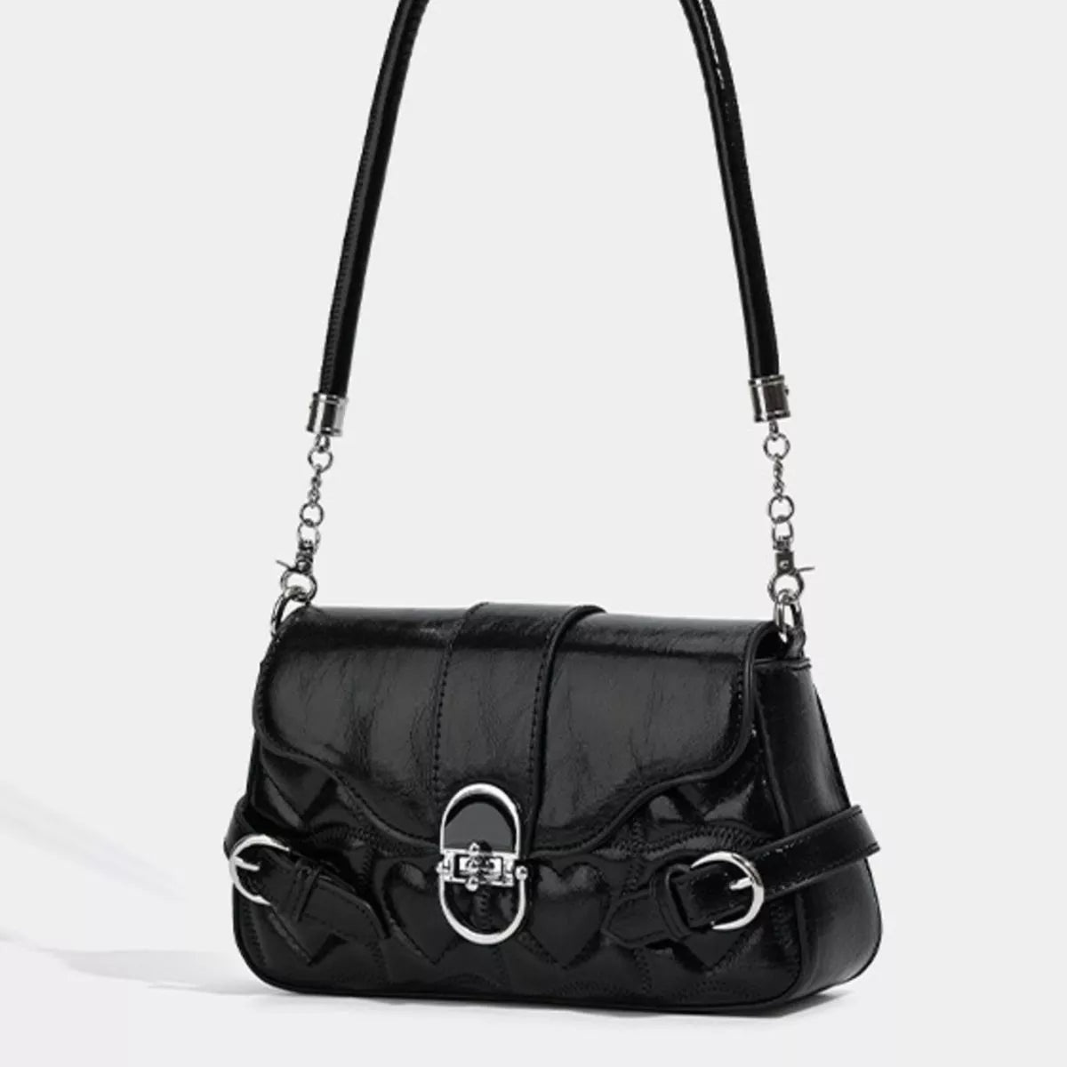 Small black PU leather crossbody bag with a quilted lower body, curved flap, central buckle closure, side buckle accents, and a chain-linked shoulder strap.