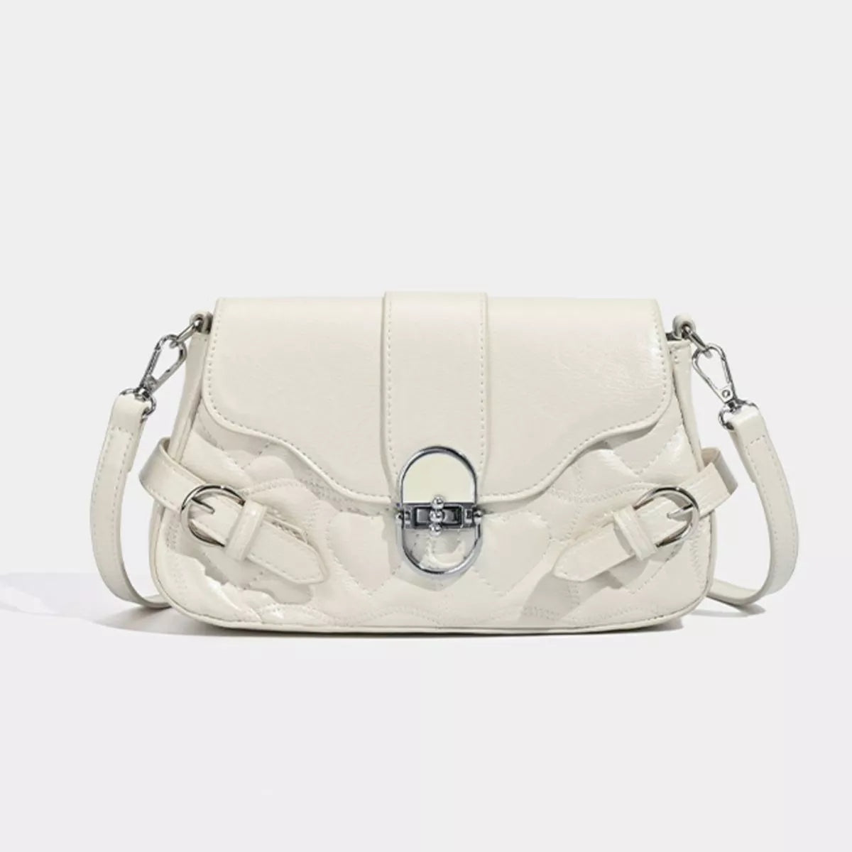 Small cream PU leather crossbody bag with a quilted body, flap closure, central buckle detail, and slim shoulder strap.