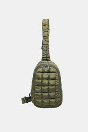 Olive green quilted nylon crossbody bag with a softly padded grid pattern, rounded elongated silhouette, adjustable strap, and dual-zip top opening.