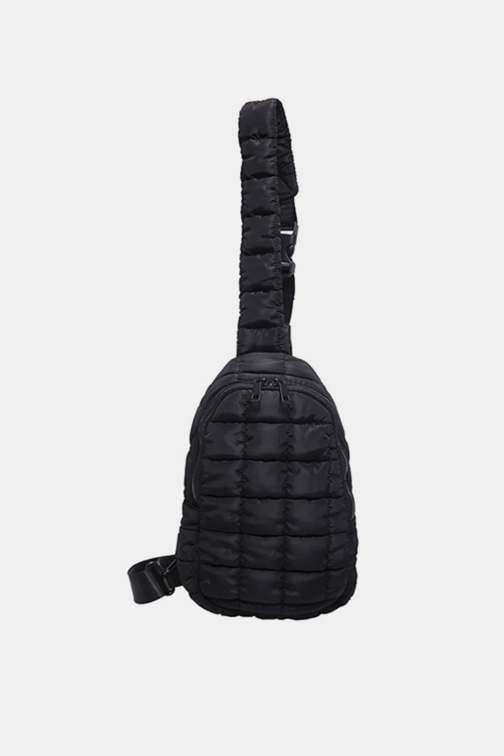 Black quilted nylon crossbody bag with a softly padded, elongated silhouette, rounded edges, zip opening, and adjustable strap.