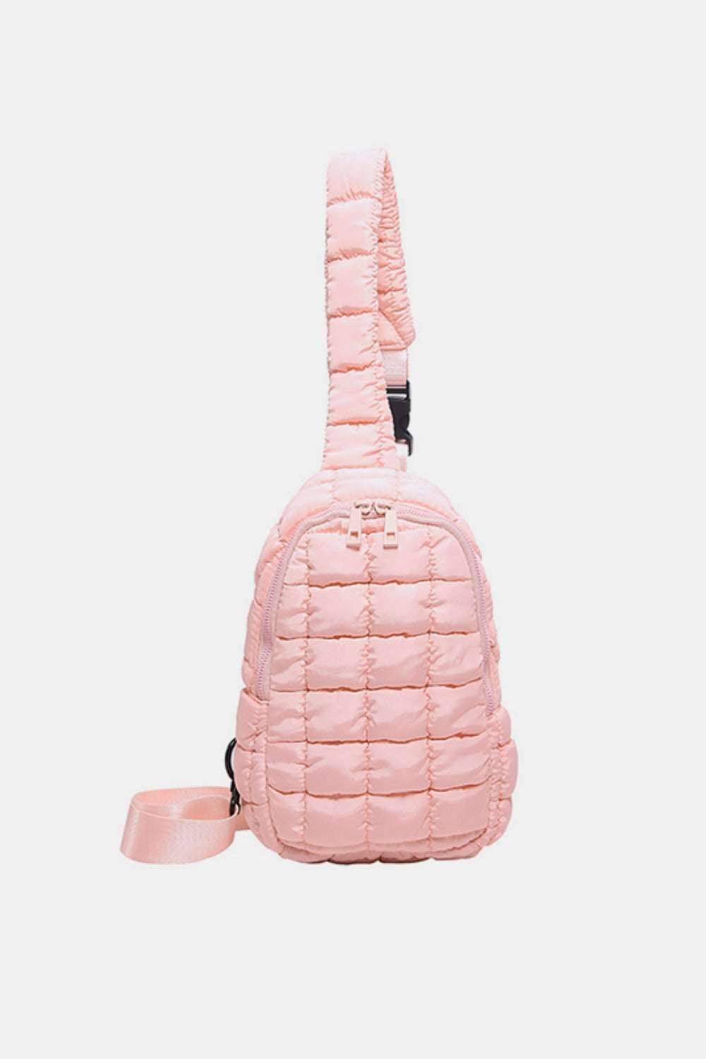Pink quilted nylon crossbody bag with a softly padded grid texture, rounded compact silhouette, zip-around opening, and adjustable strap.