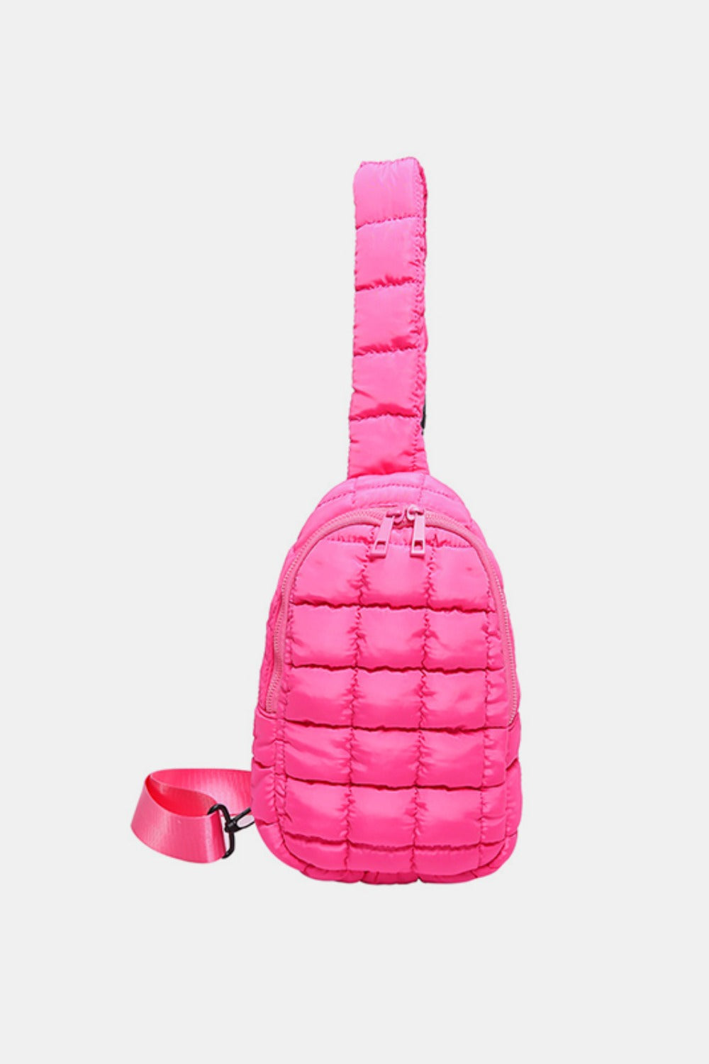 Bright pink quilted nylon crossbody bag with a softly padded grid pattern, rounded silhouette, top zip closure, and adjustable matching strap.