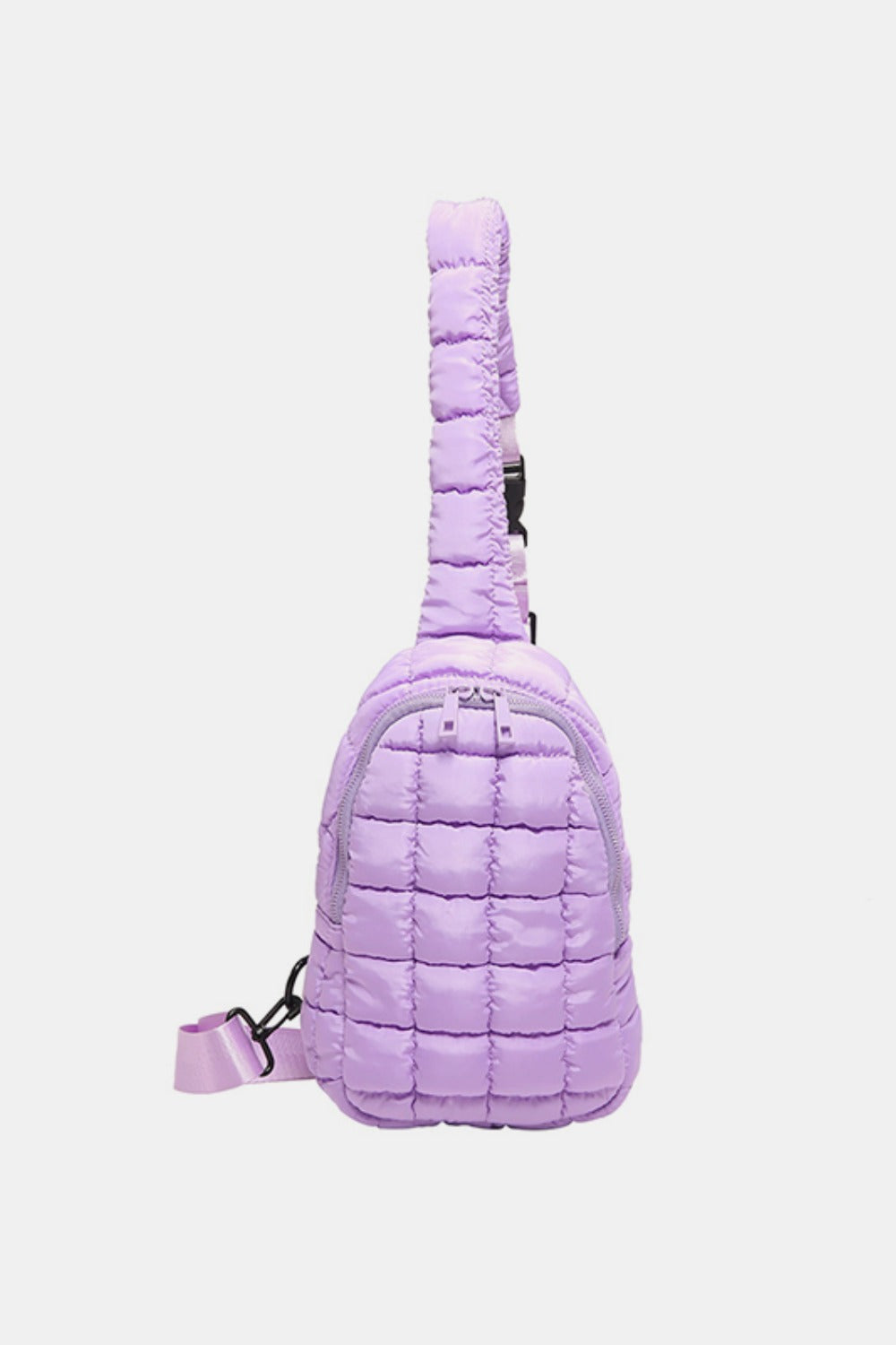 Lavender quilted nylon crossbody bag with a softly padded grid pattern, rounded silhouette, zip-around opening, and adjustable strap with black hardware.