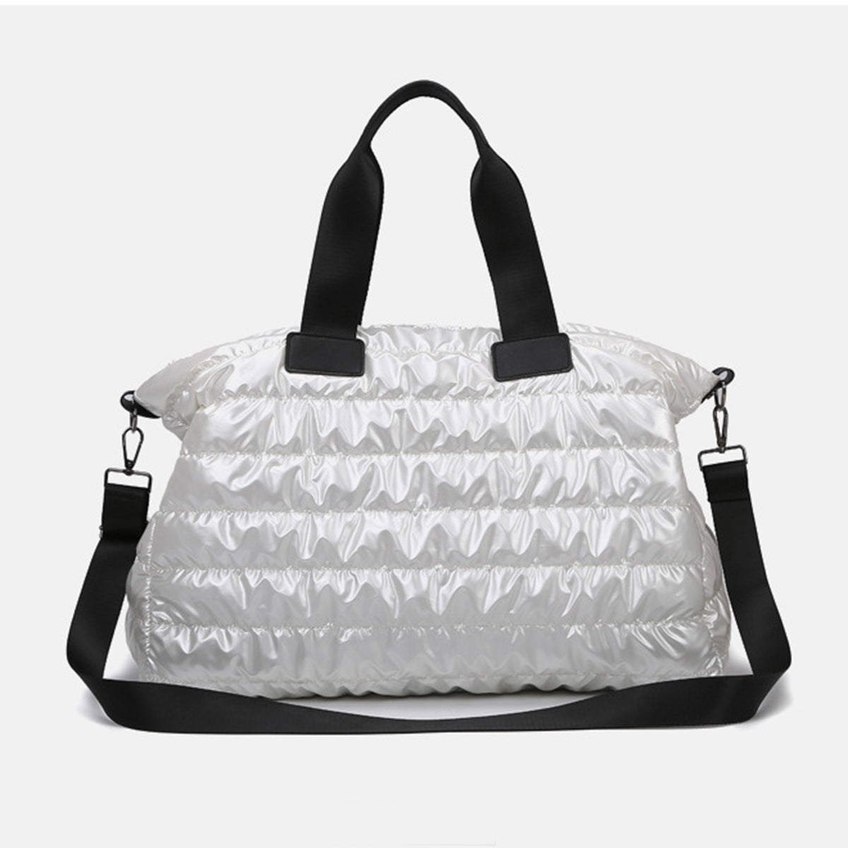 A white quilted nylon oversize travel bag features a softly padded silhouette, black top handles, and a long detachable shoulder strap.