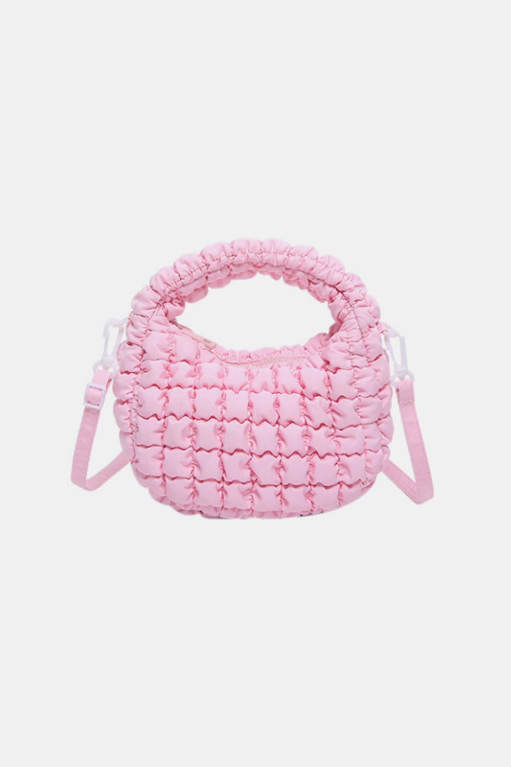 Pink quilted puffy crossbody bag with a rounded silhouette, gathered padded top handle, and removable matching strap for versatile carrying.