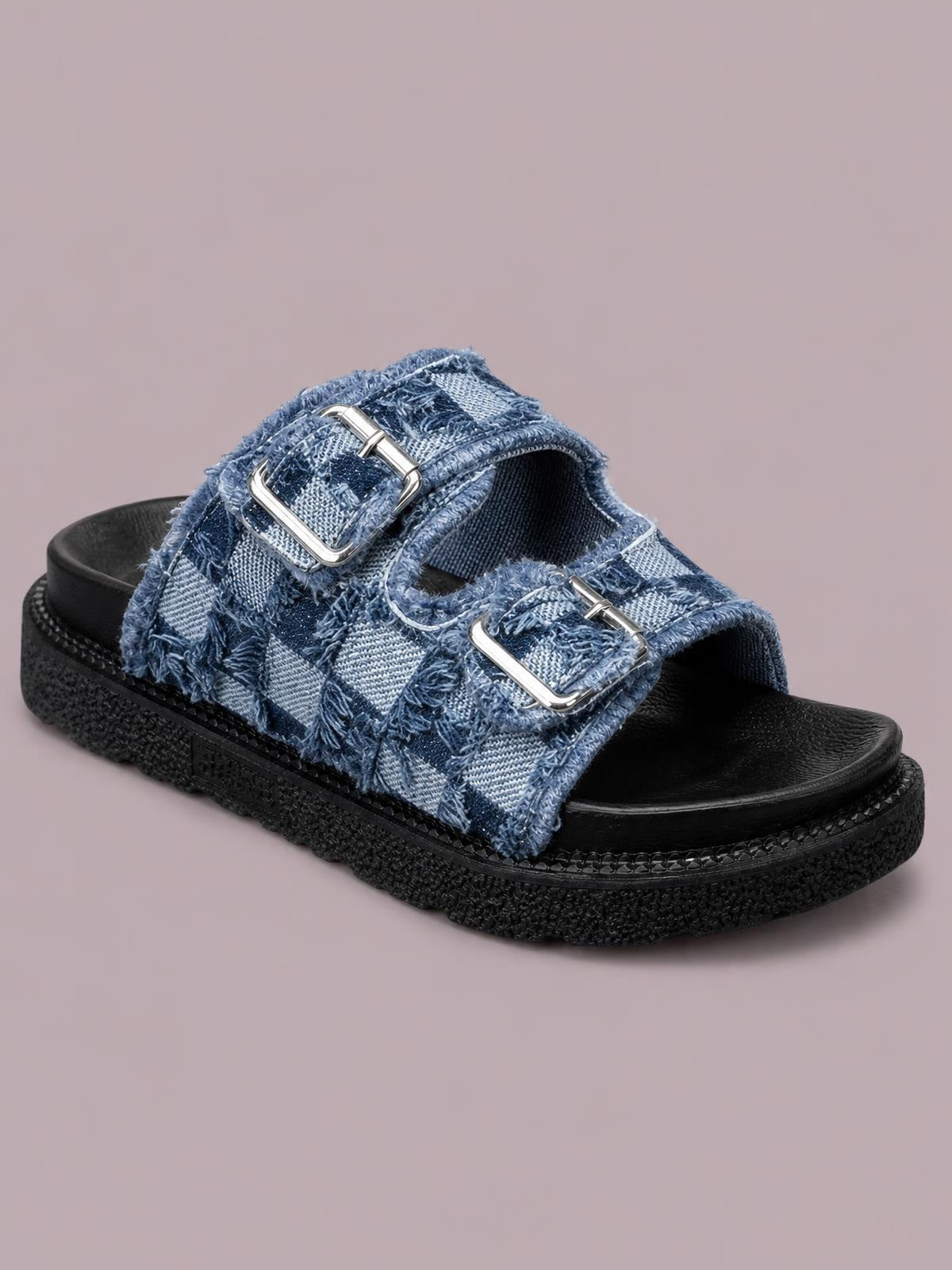 Blue checkered cloth buckle sandals feature raw-edge straps, silver buckles, open toes, and a chunky black rubber flat sole.