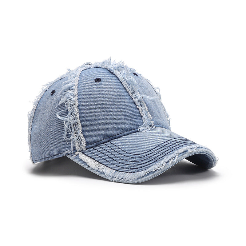 Light blue cotton baseball cap with a relaxed six-panel crown, curved brim, tonal stitching, ventilation eyelets, and distinctive raw frayed hems.