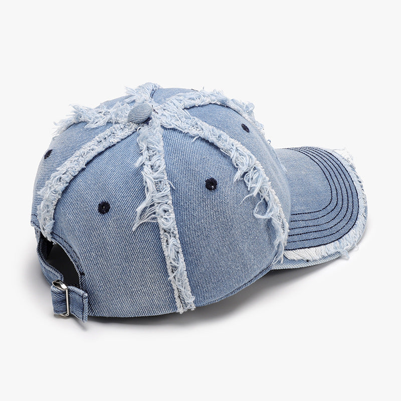 Light blue cotton baseball cap with a six-panel crown, raw frayed hems, tonal brim stitching, ventilation eyelets, and an adjustable back strap.