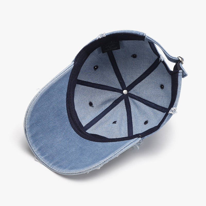 Light blue cotton baseball cap shown from the inside, featuring a six-panel crown, ventilation eyelets, raw hems, curved brim, and adjustable back strap.
