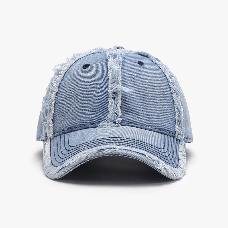 Light blue cotton baseball cap with a six-panel crown, curved brim, ventilation eyelets, tonal stitching, and distinctive frayed raw hems.