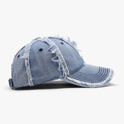 Light blue cotton baseball cap with a relaxed six-panel silhouette, curved brim, ventilation eyelets, adjustable back strap, and distinctive raw frayed hems.