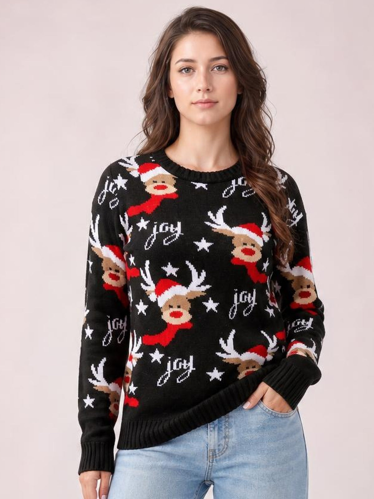 Model wearing a black round neck reindeer sweater with long sleeves, ribbed cuffs and hem, and a relaxed silhouette, posing with one hand in her jeans pocket.