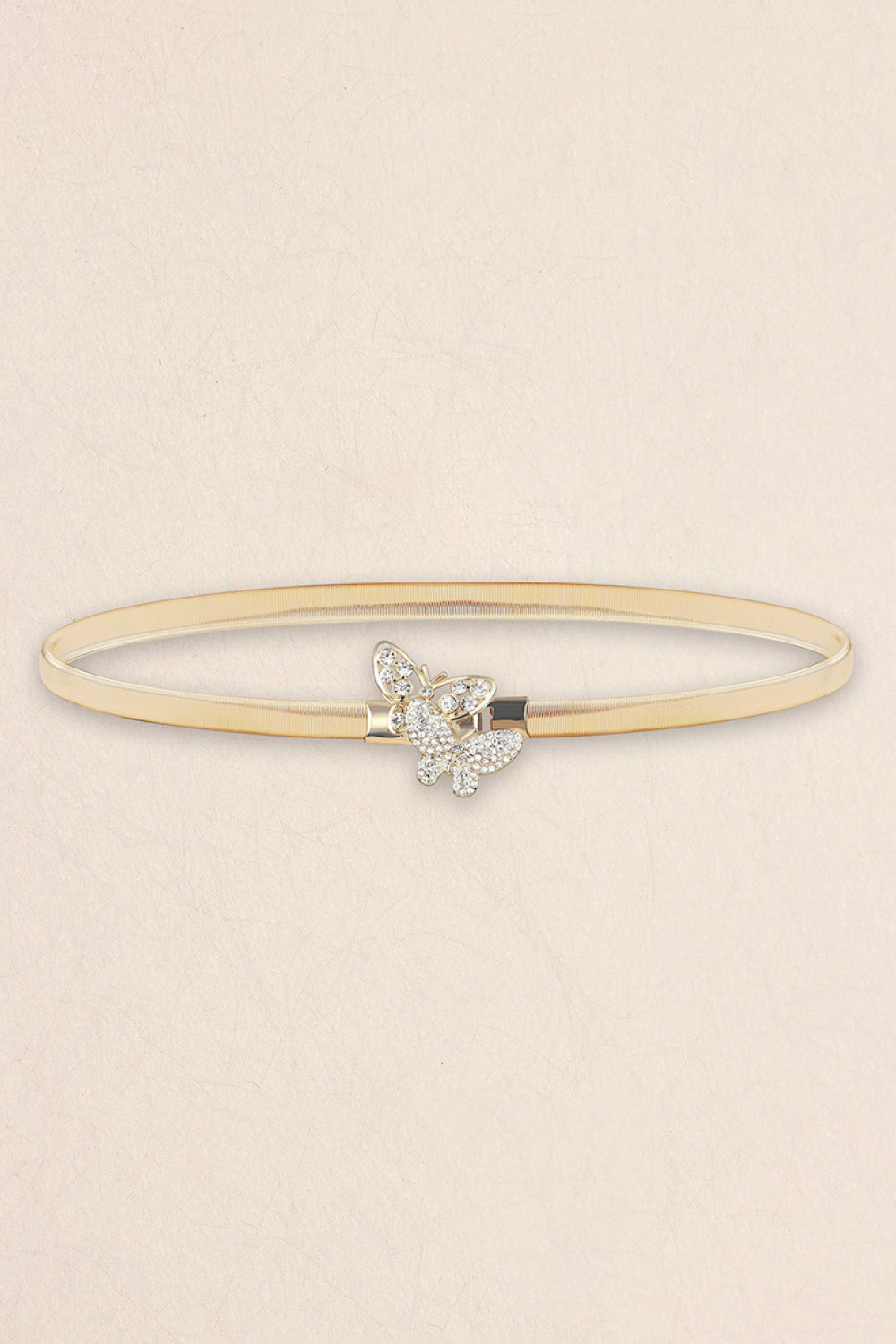 Slim gold elastic metal belt featuring a sparkling rhinestone butterfly centerpiece and sleek construction for defining dresses, blouses, or high-waisted skirts.