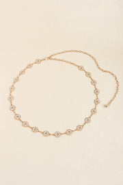 Slim gold-tone zinc alloy belt with linked chain construction and a succession of sparkling circular rhinestone accents for an elegant, jewelry-inspired drape.
