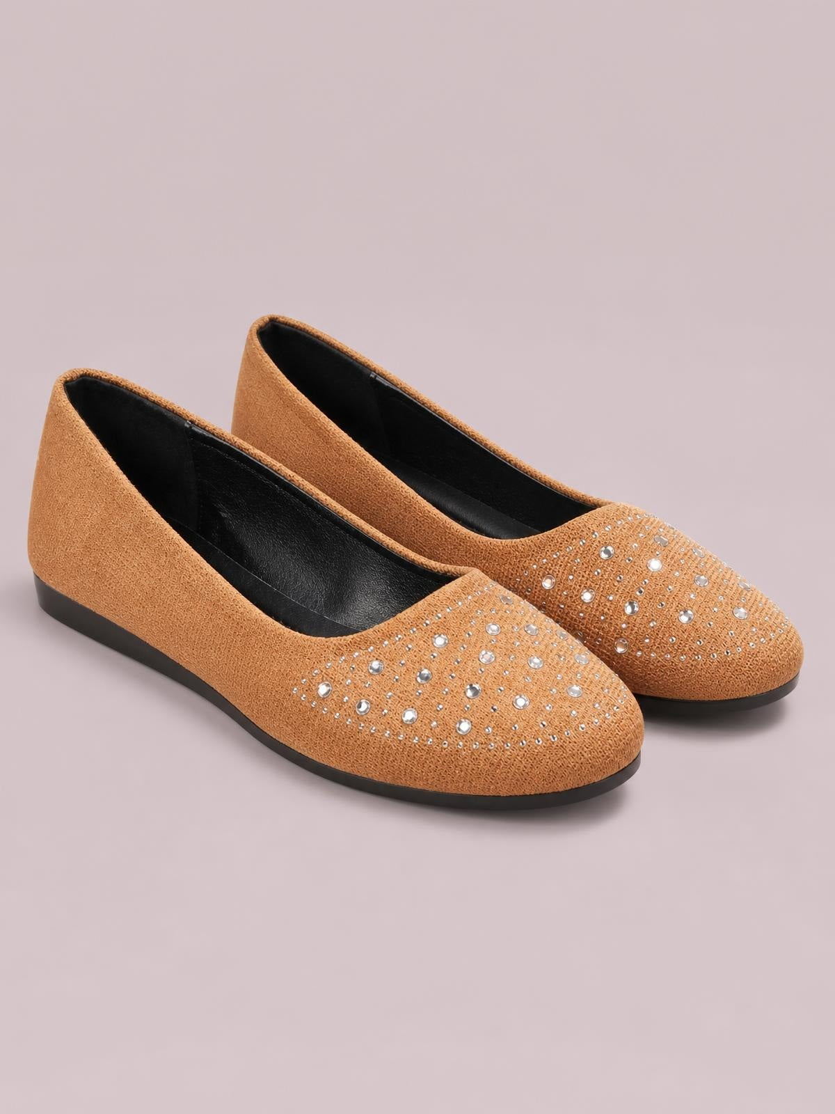 Tan flat slip-on shoes feature rounded toes, PU leather uppers, scattered rhinestone embellishments, black interiors, and rubber soles.