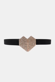 Black elastic belt with a slim band and large heart-shaped buckle covered in sparkling rhinestones, creating a polished statement accessory.