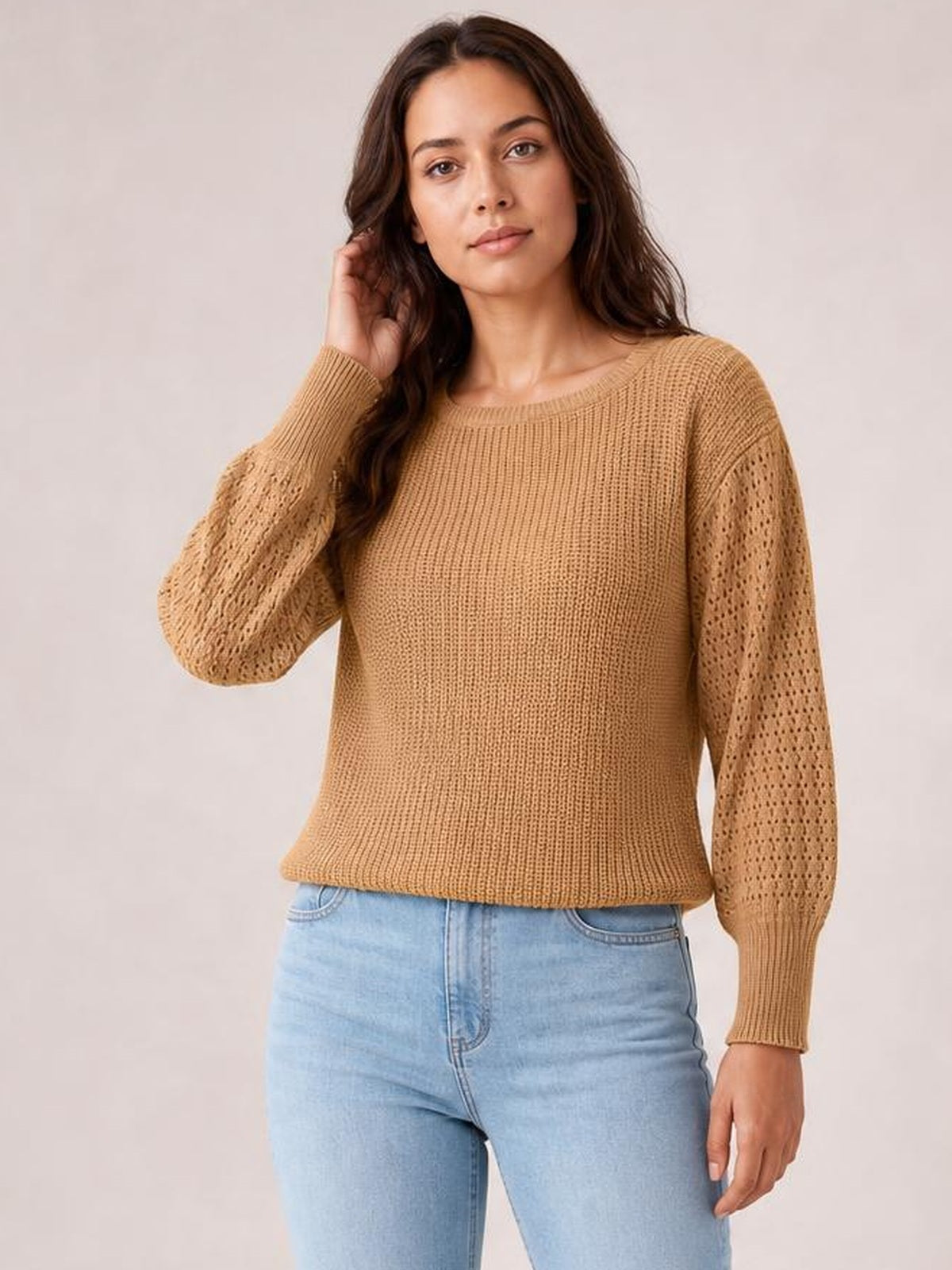 Model wearing a camel ribbed round-neck pullover sweater with openwork long sleeves, dropped shoulders, ribbed cuffs and a regular relaxed silhouette.