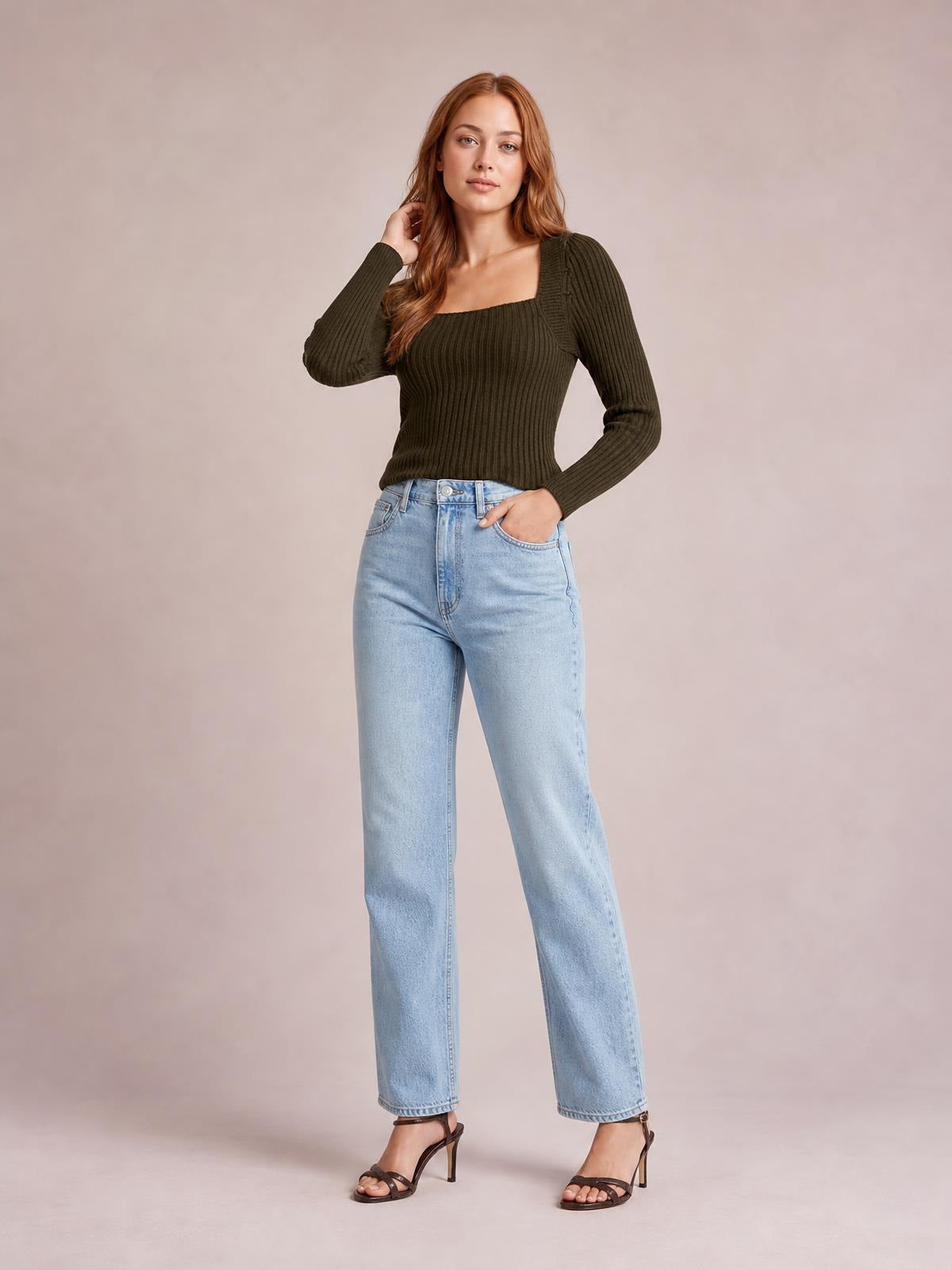 A model poses in a dark olive ribbed square-neck long-sleeve sweater with a fitted silhouette, one hand in her jeans pocket and the other touching her hair.