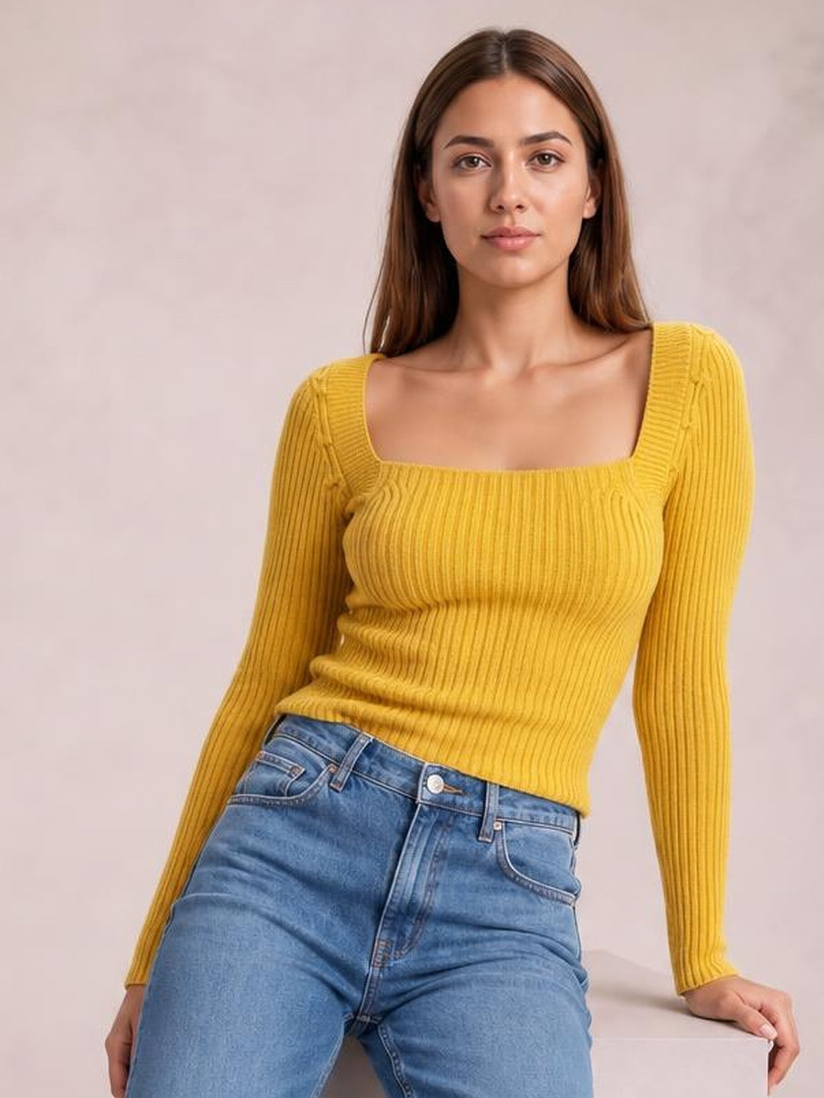 Model wears a mustard yellow ribbed square-neck sweater with long sleeves, a fitted stretchy silhouette, and visible vertical knit construction.