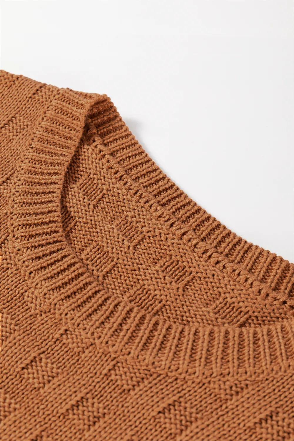 Close-up of a warm brown knitted sweater vest showing the round neckline, ribbed trim, textured stitch construction, and soft slightly stretchy fabric.