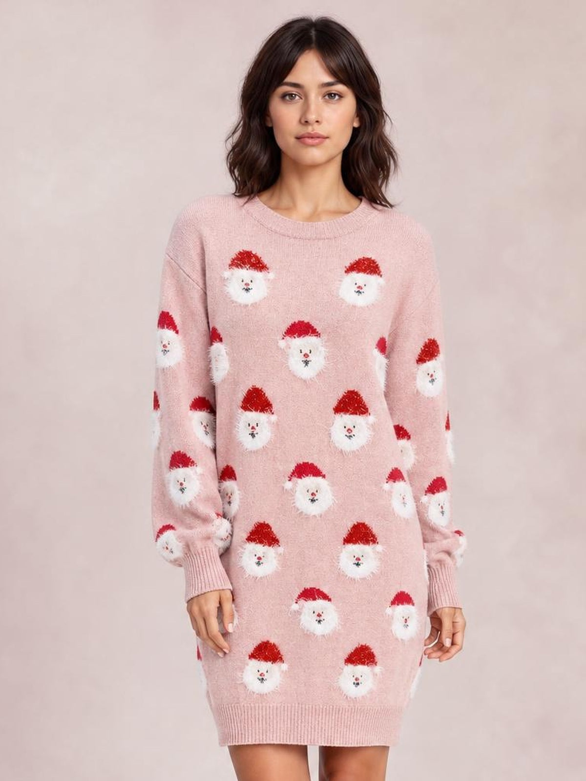 Model wearing a pink round neck dropped shoulder sweater dress with a relaxed silhouette, long sleeves, ribbed cuffs and hem, and Santa face pattern.