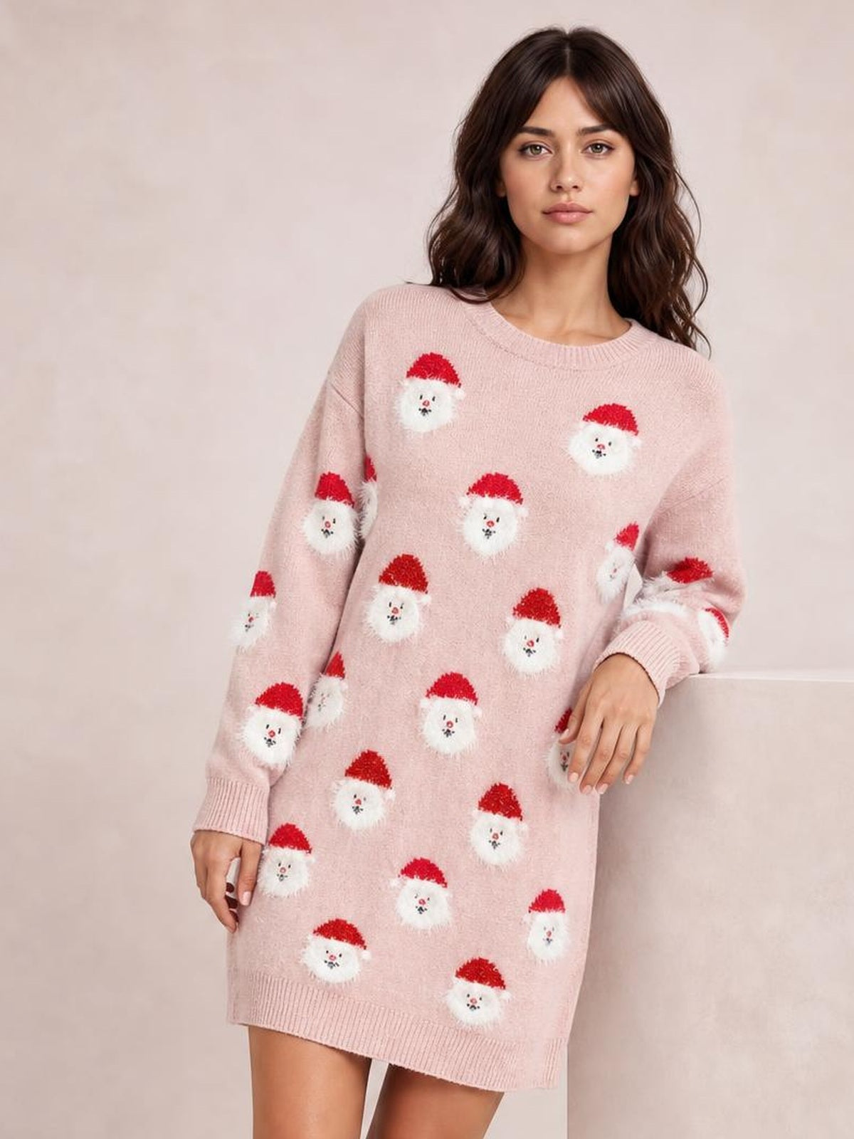 Model wears a pink round-neck dropped-shoulder sweater dress with a relaxed mini silhouette, long sleeves, ribbed cuffs and hem, and an allover Santa motif.
