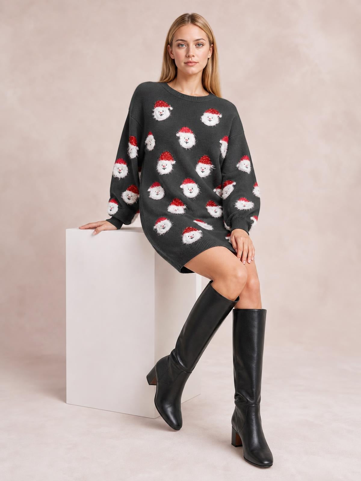 A model sits in a dark gray round-neck sweater dress with dropped shoulders, oversized sleeves, ribbed trim, and a repeating Santa face pattern.