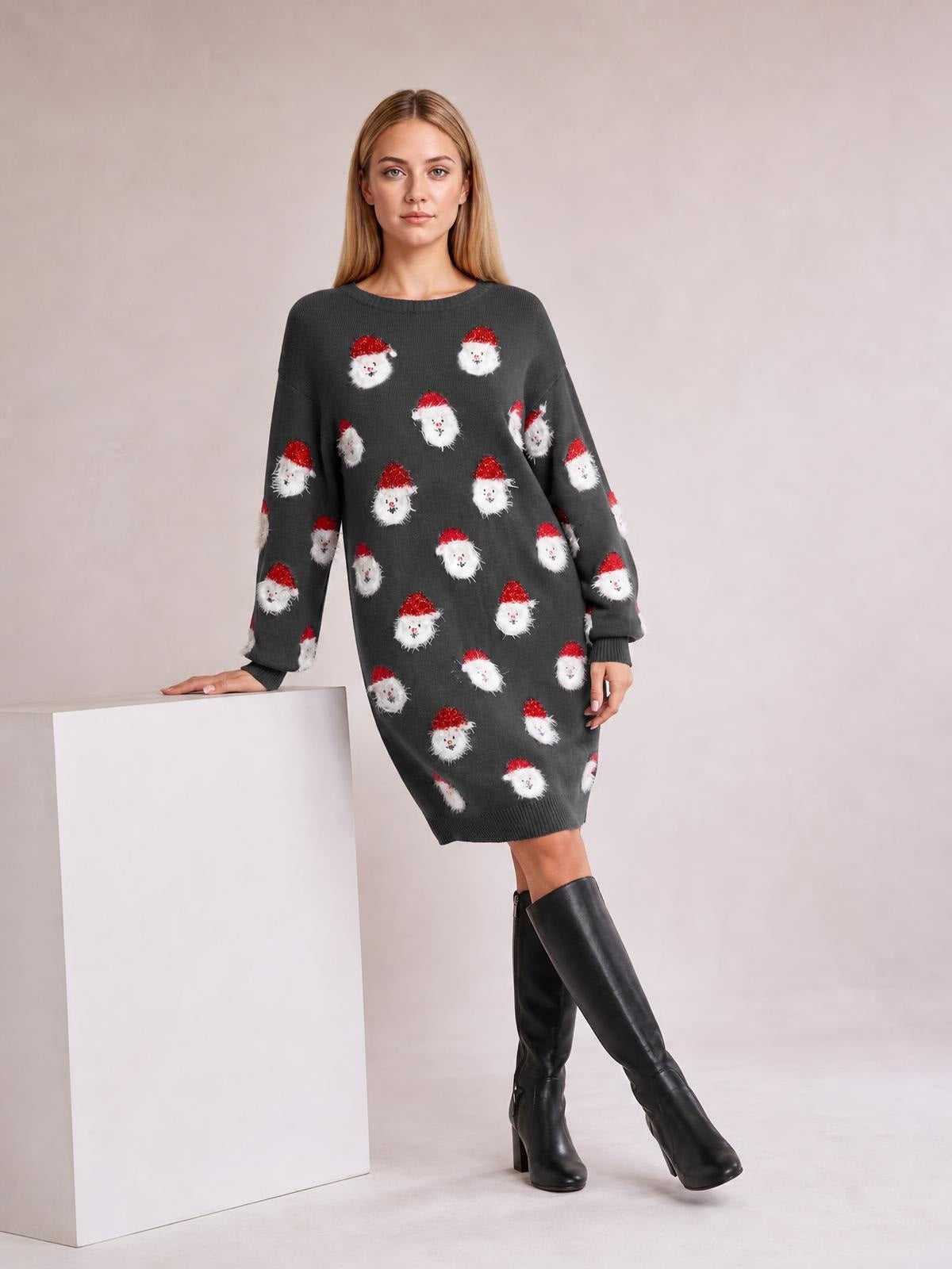 Model wearing a charcoal round neck dropped shoulder sweater dress with long sleeves, ribbed cuffs and hem, relaxed silhouette, and Santa face print.