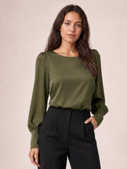 Model wears an olive green round-neck blouse with a relaxed silhouette, softly gathered shoulders, long lantern sleeves, and fitted cuffs.