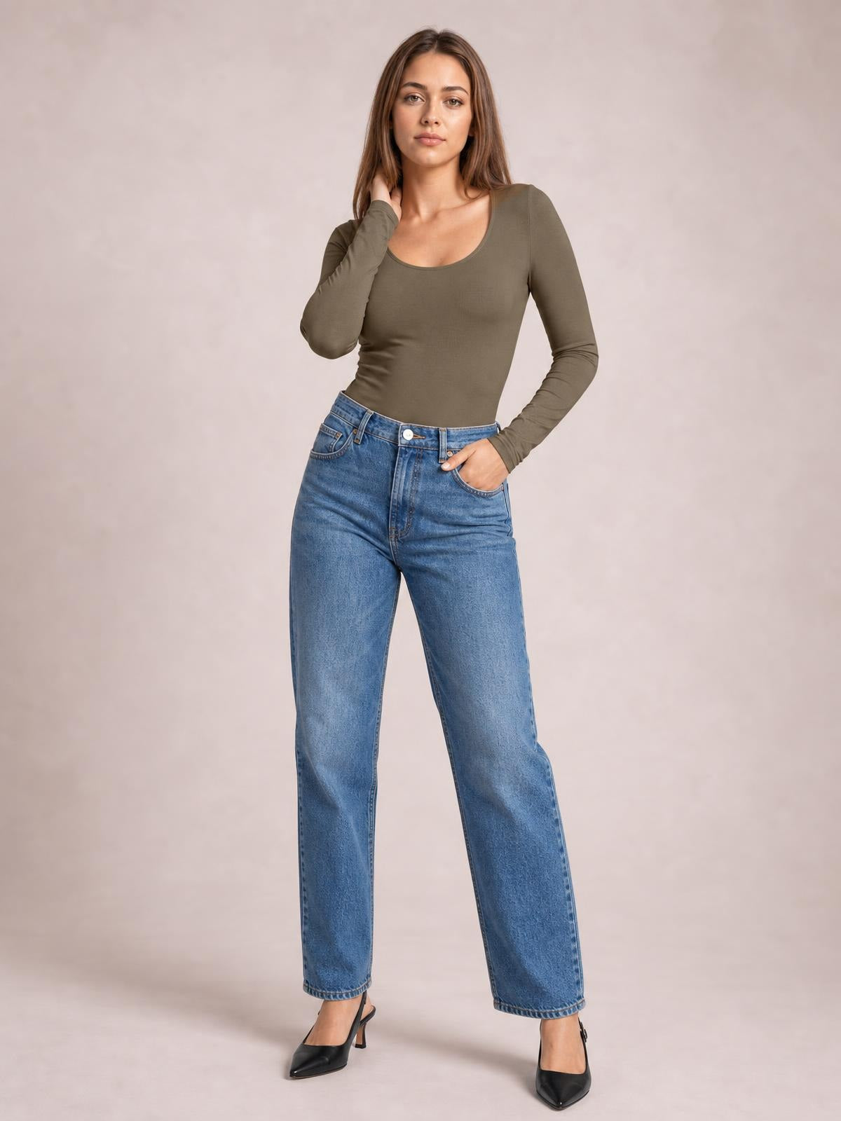 Model wears an olive round-neck long-sleeve bodysuit with an opaque, fitted silhouette and moderate stretch, posing with one hand at her neck.