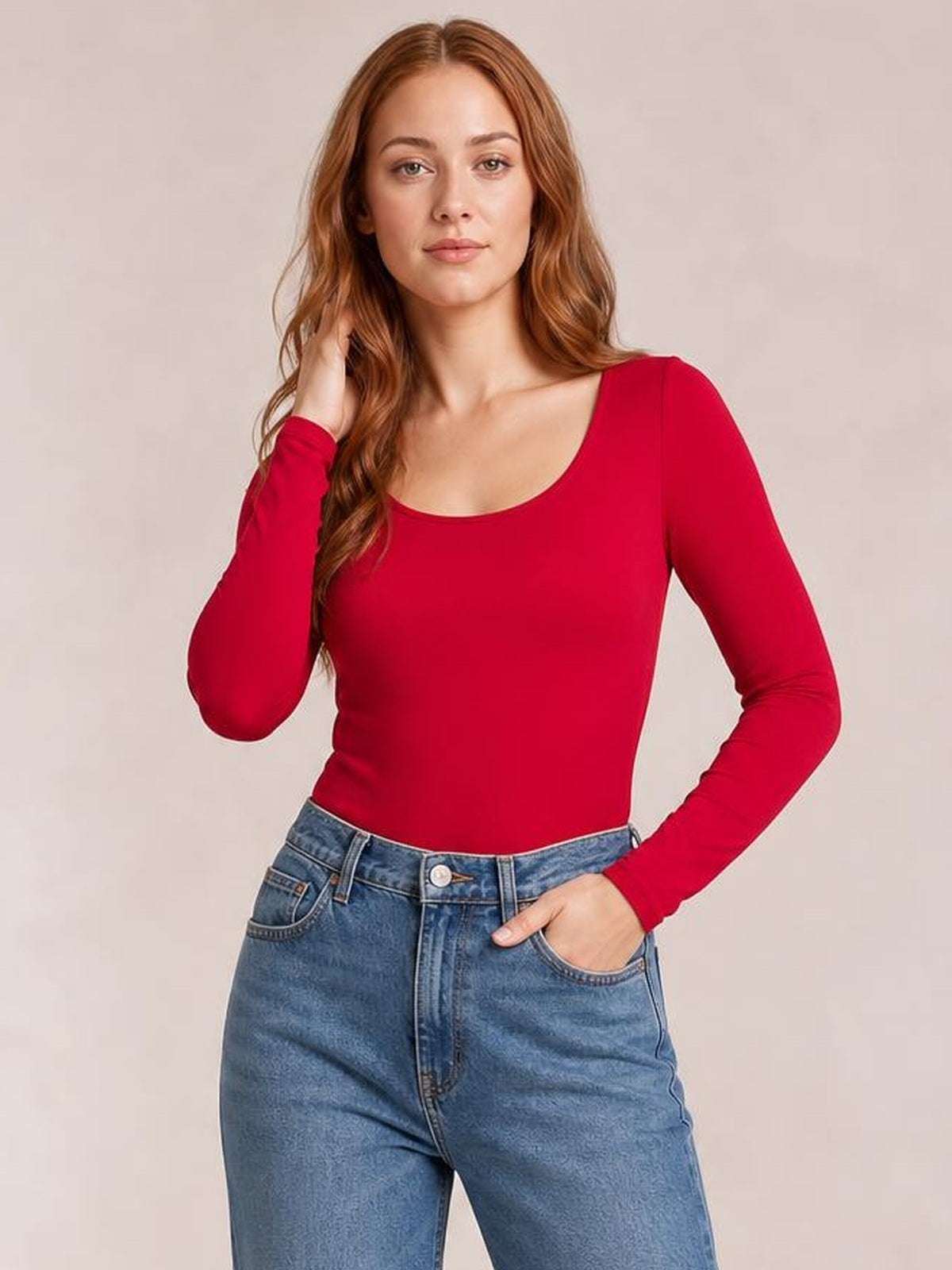 Model wears a red round-neck long-sleeve bodysuit with a fitted silhouette, posing with one hand in her jeans pocket and the other touching her hair.