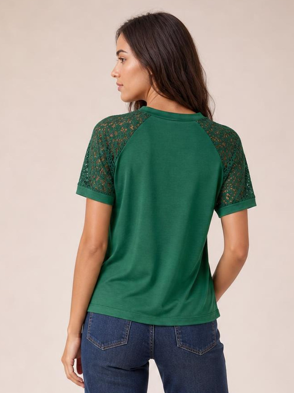 Model shown from behind in a relaxed pose wearing a green round neck short sleeve T-shirt with lace raglan sleeves, cuffed hems, and a straight silhouette.
