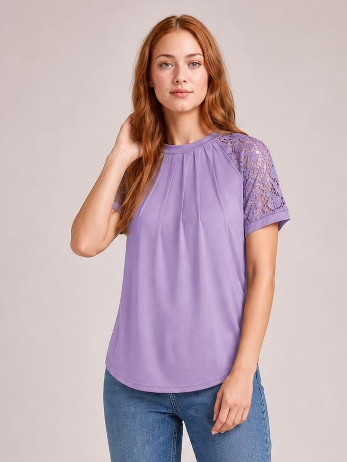 Model poses in a lavender round neck short sleeve T-shirt with lace shoulder and sleeve details, a relaxed straight silhouette, and a softly gathered neckline.