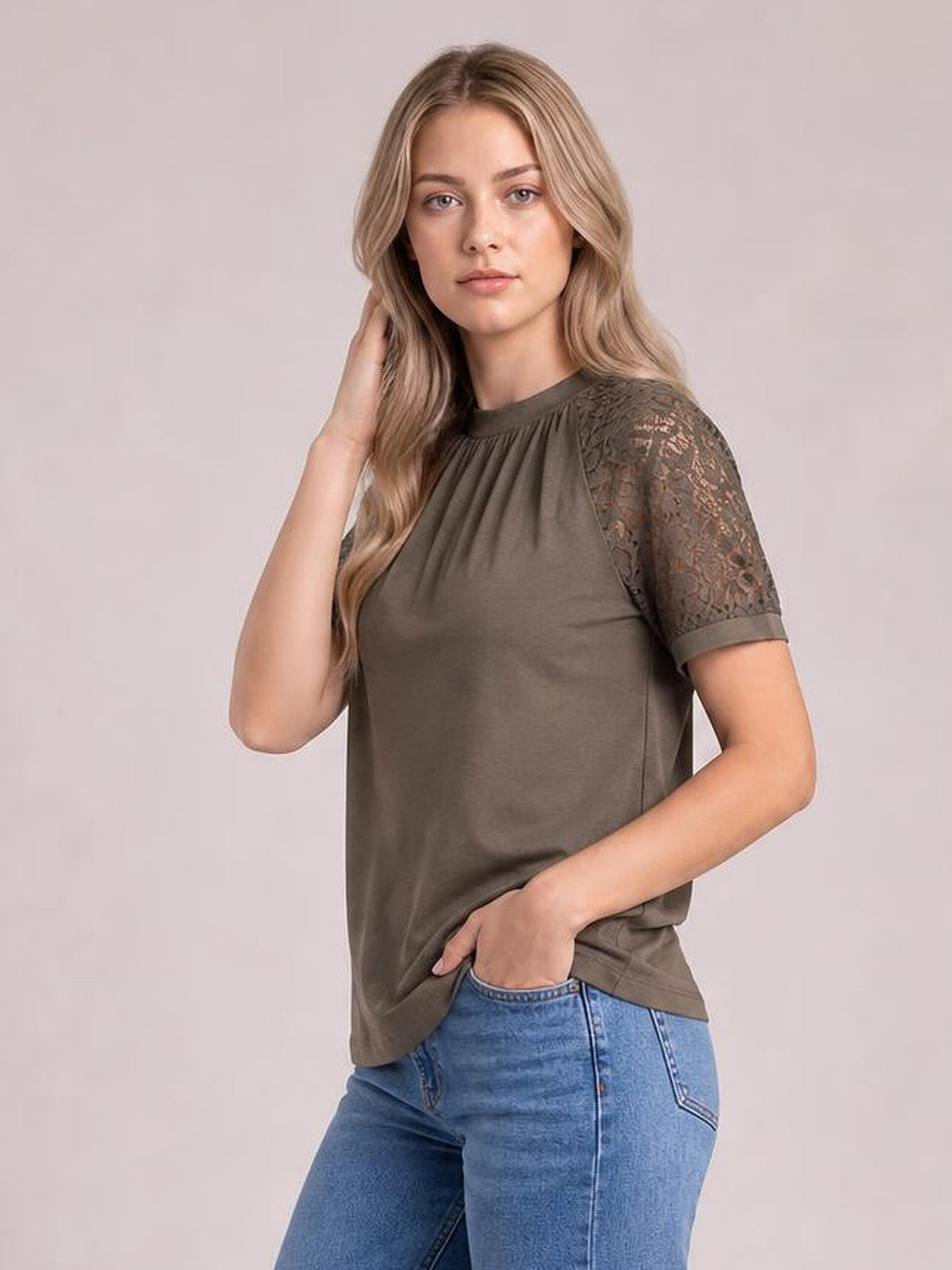 Model wearing an olive round neck short sleeve T-shirt with lace-detail sleeves, a relaxed straight silhouette, and a slightly gathered neckline.