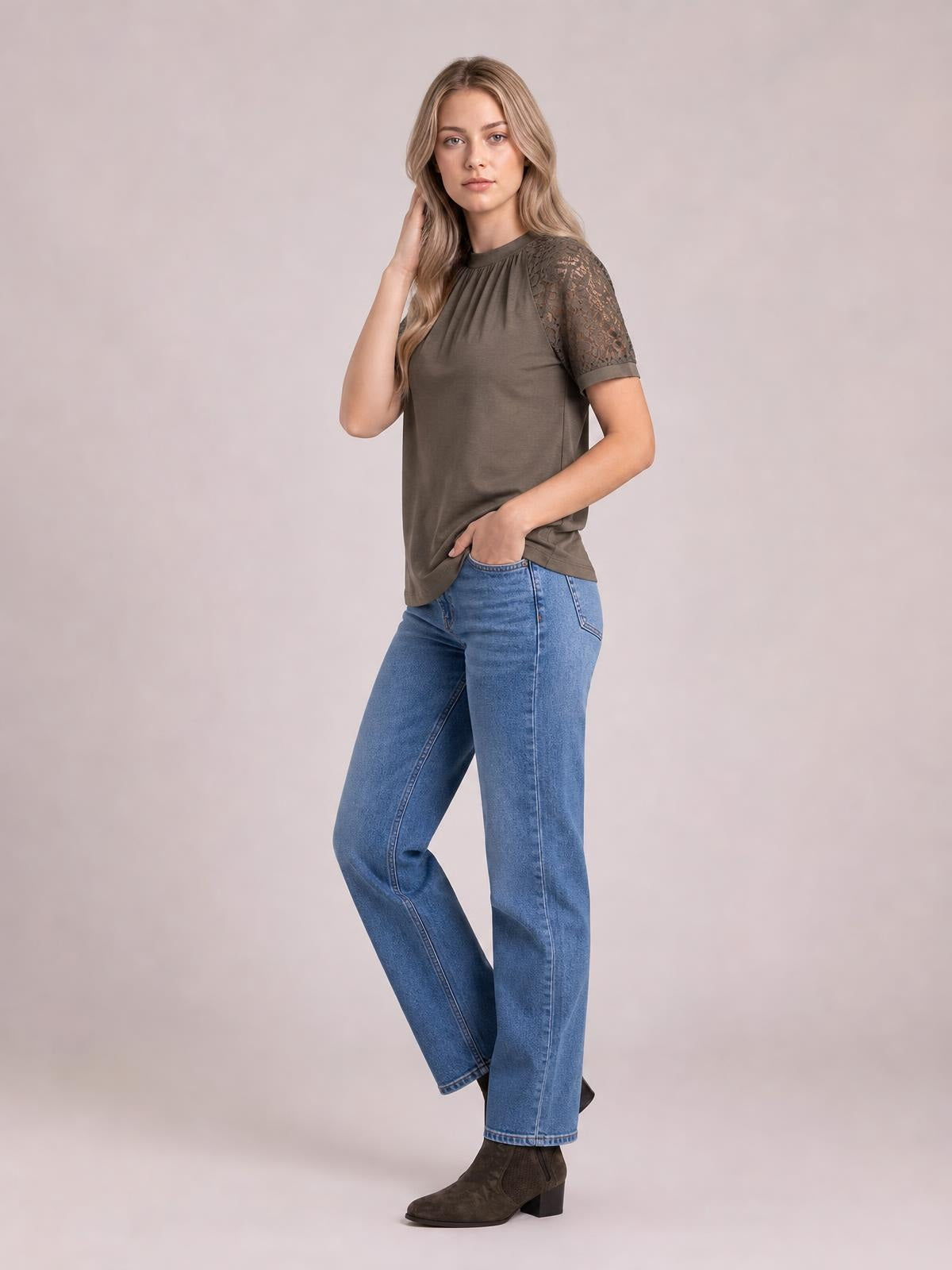 Model poses in a taupe round neck short sleeve T-shirt with gathered neckline, opaque fabric, lace-detail sleeves, and a relaxed straight silhouette.