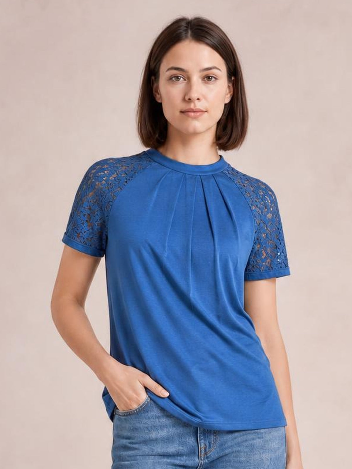 Model wearing a royal blue round neck short sleeve T-shirt with lace shoulder details, pleated front construction, and a relaxed silhouette.