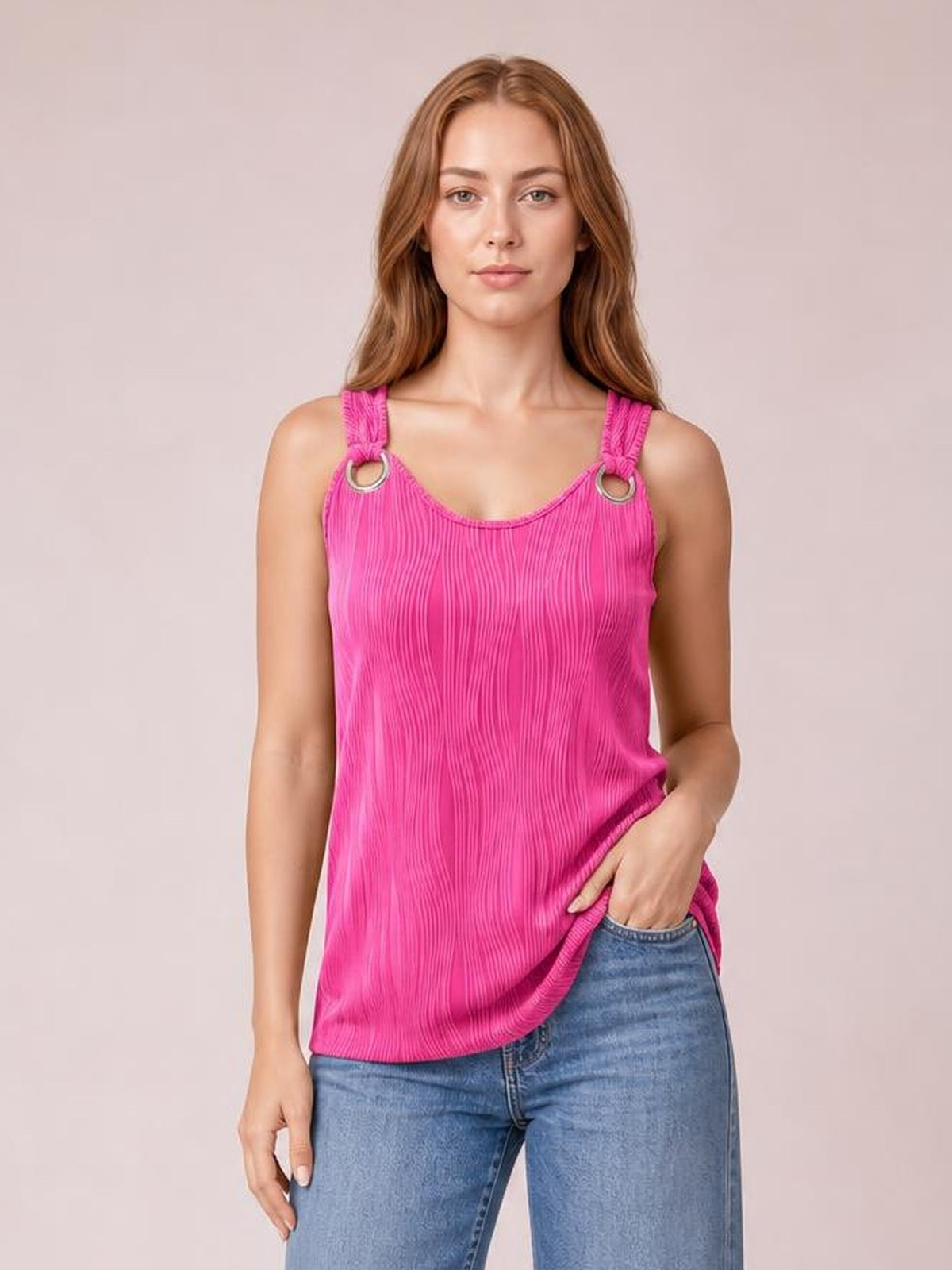 Model poses in a bright pink wide-strap tank with a round neckline, vertical texture, ring-accented shoulder straps, and a relaxed silhouette.