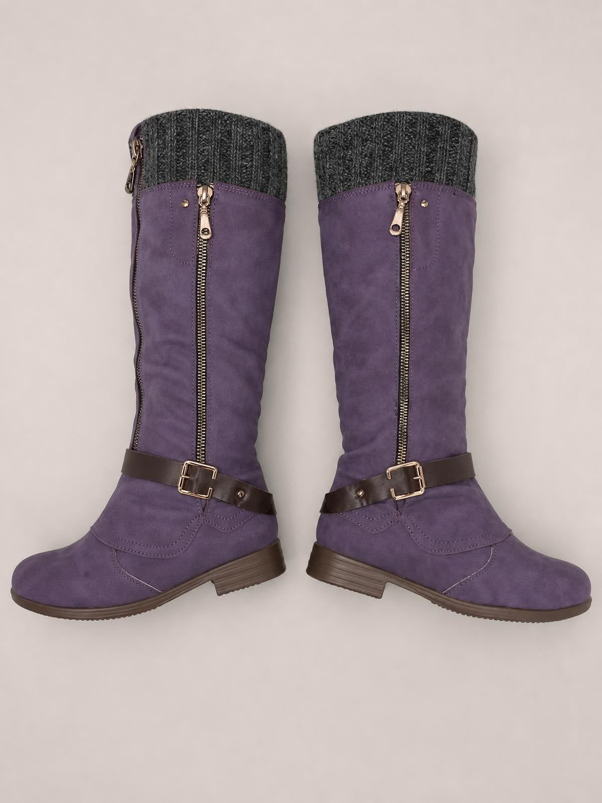Purple suede round-toe block heel boots feature tall shafts, gray knit cuffs, front zippers, brown buckle straps, and sturdy rubber soles.