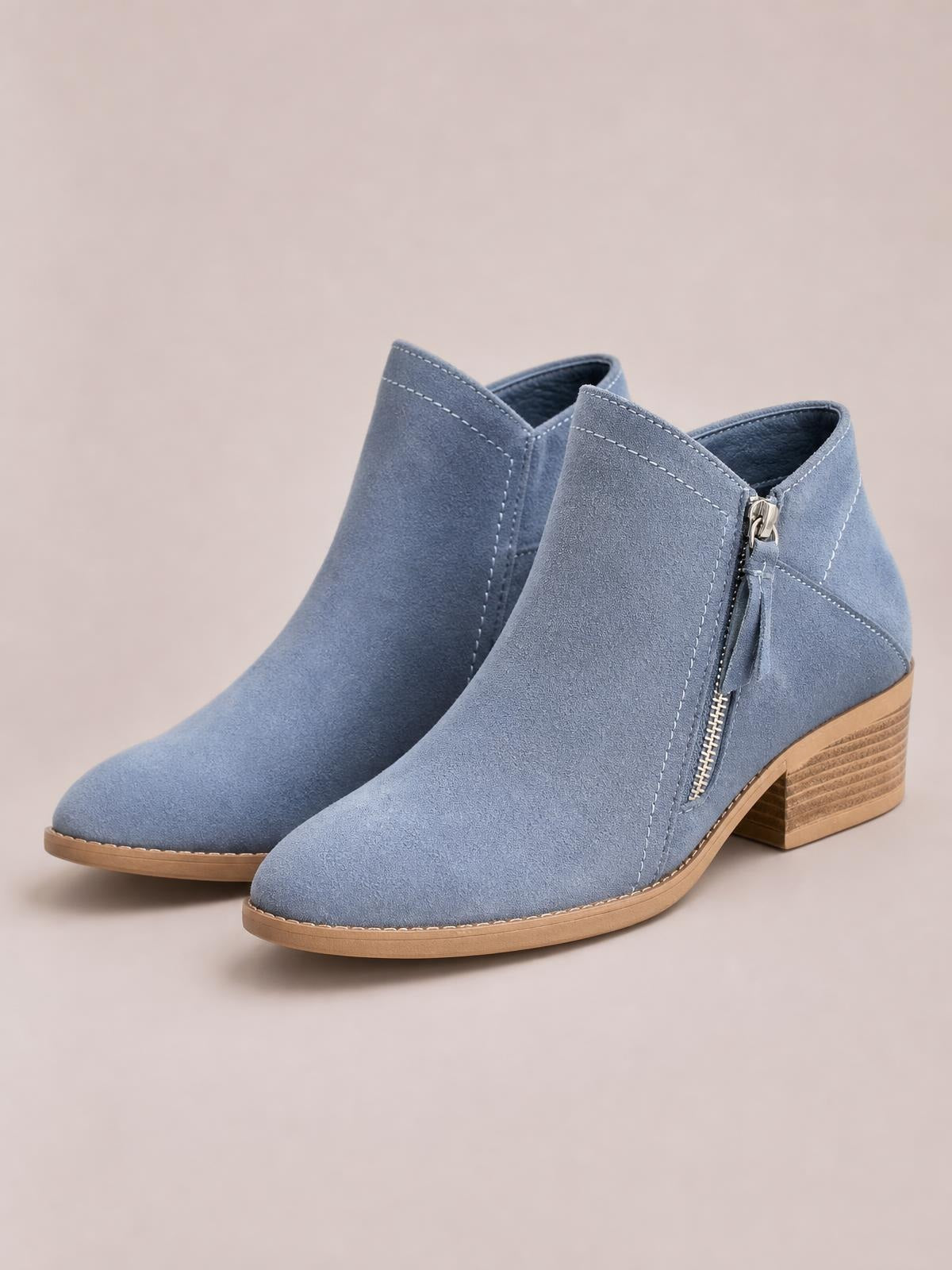 Blue PU leather round toe ankle boots with side zippers, visible stitching, tan rubber soles, and low stacked block heels.