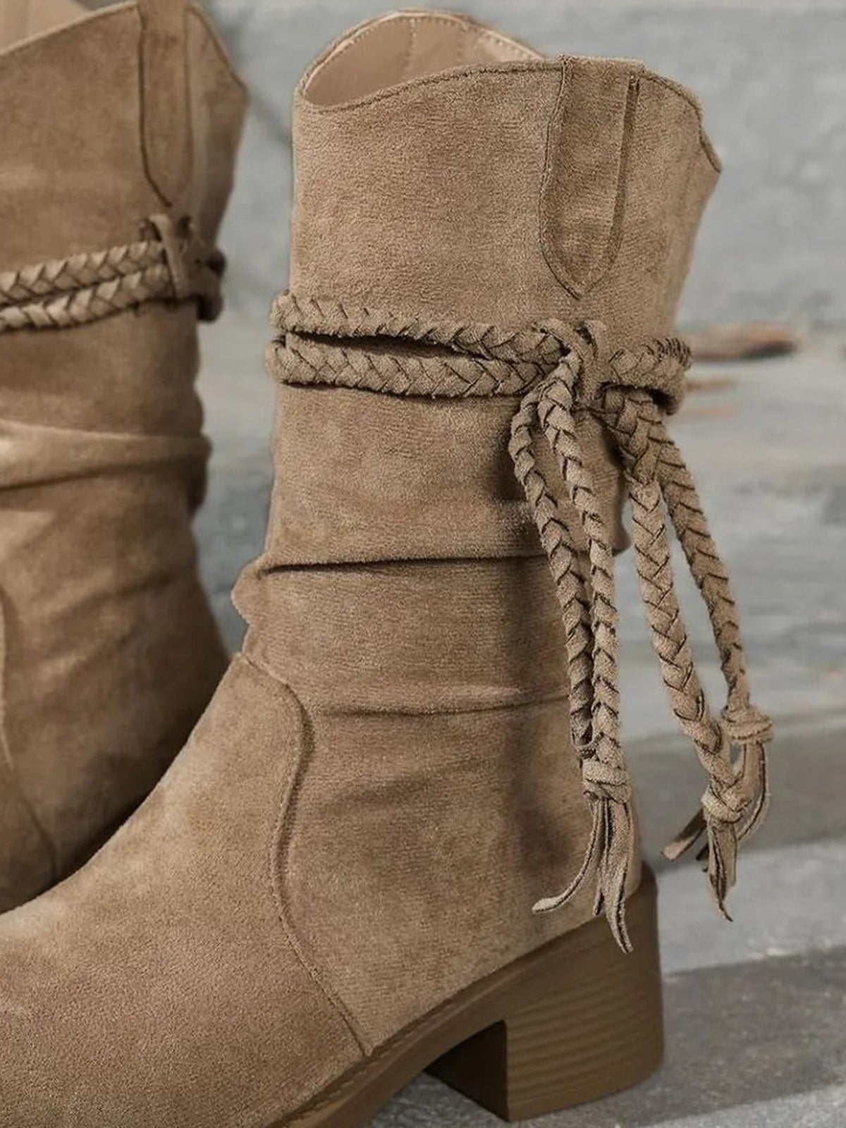 Tan round toe block heels boots feature a softly ruched shaft, braided wraparound ties with tassels, and sturdy mid-height block heels.