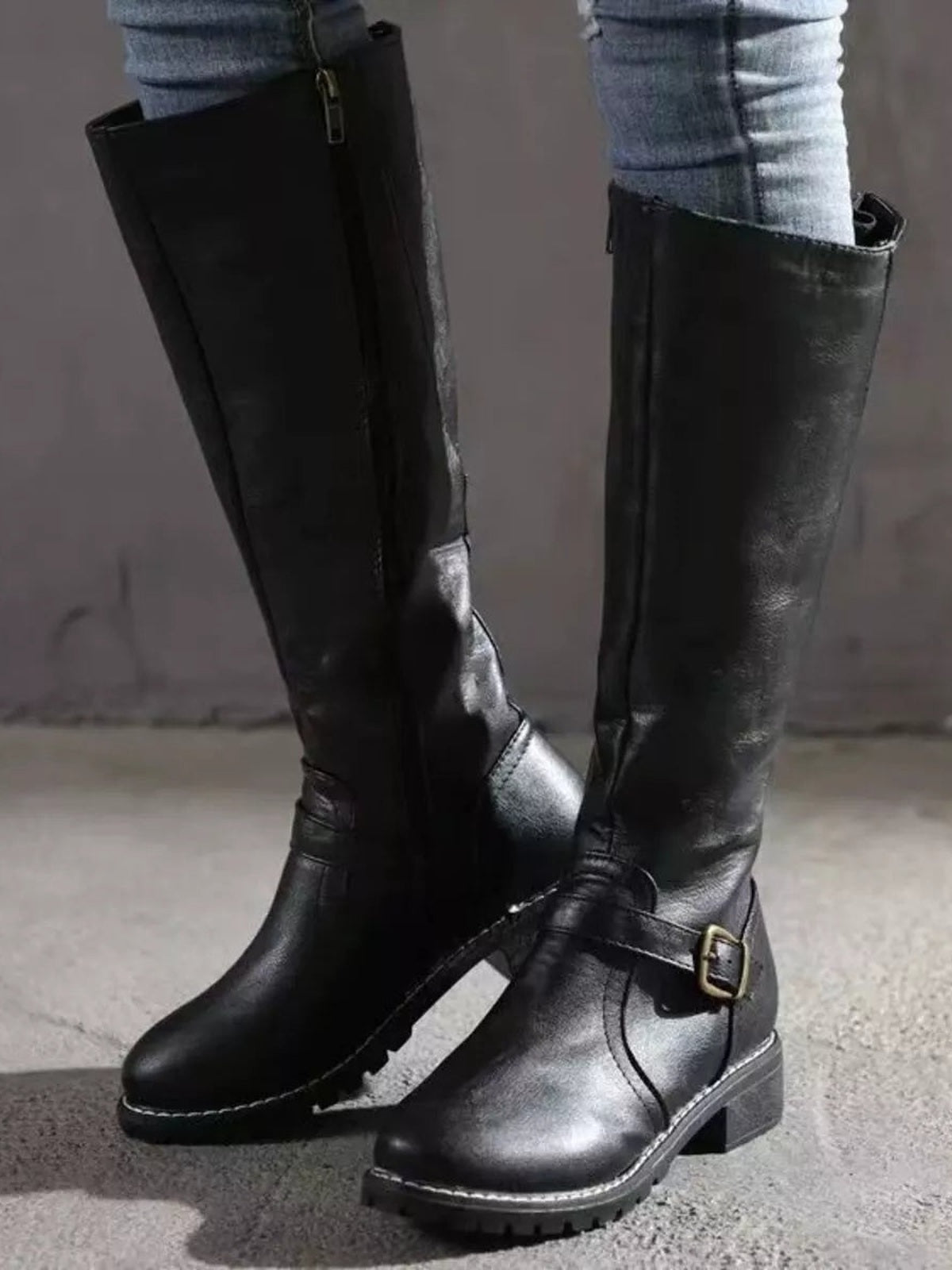 Black PU leather round-toe block-heel boots with tall shafts, side buckled straps, visible stitching, and textured rubber soles.