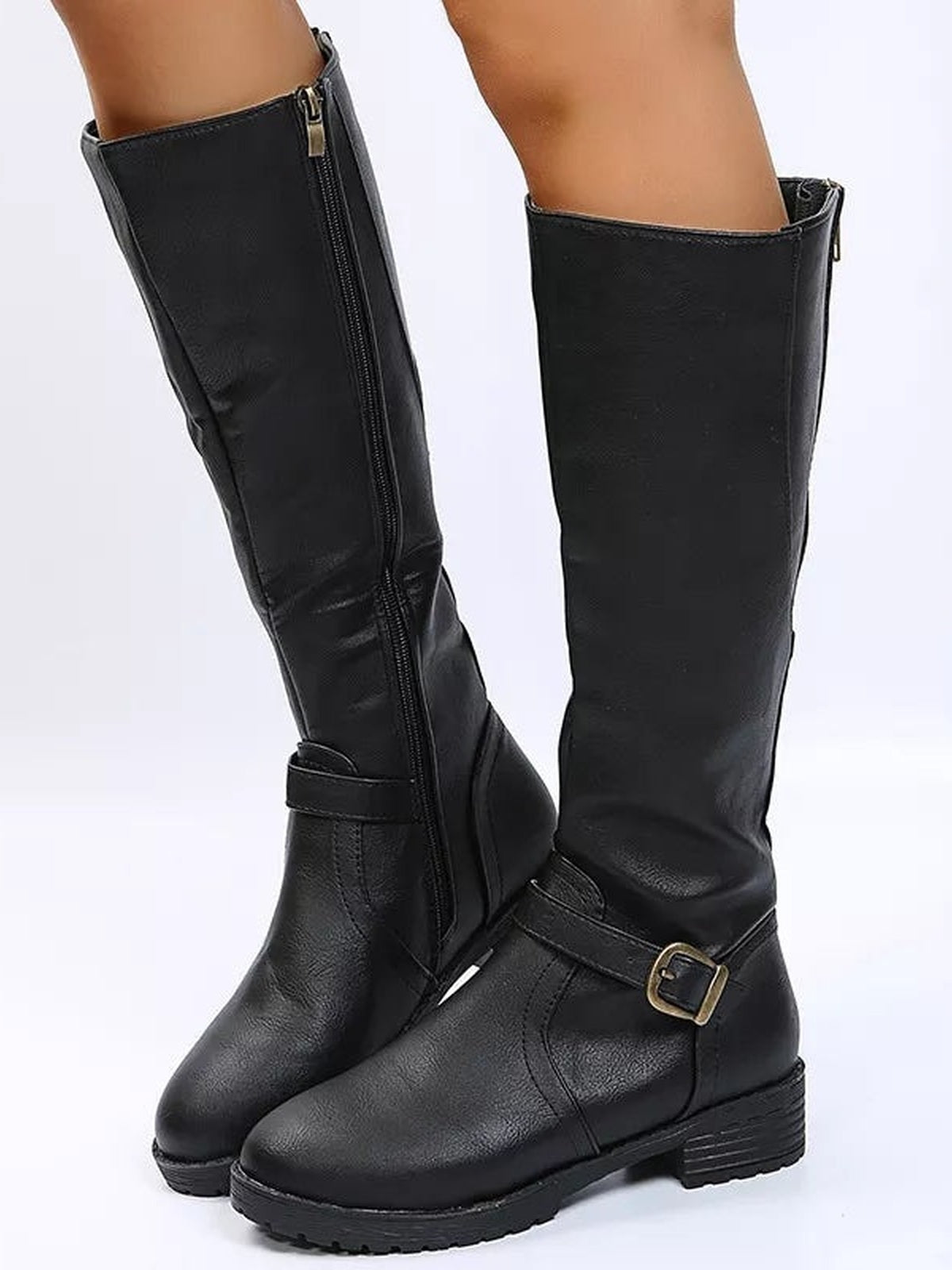 Model wears black PU leather knee-high boots with round toes, low block heels, side zippers, and ankle straps with gold-tone buckles.