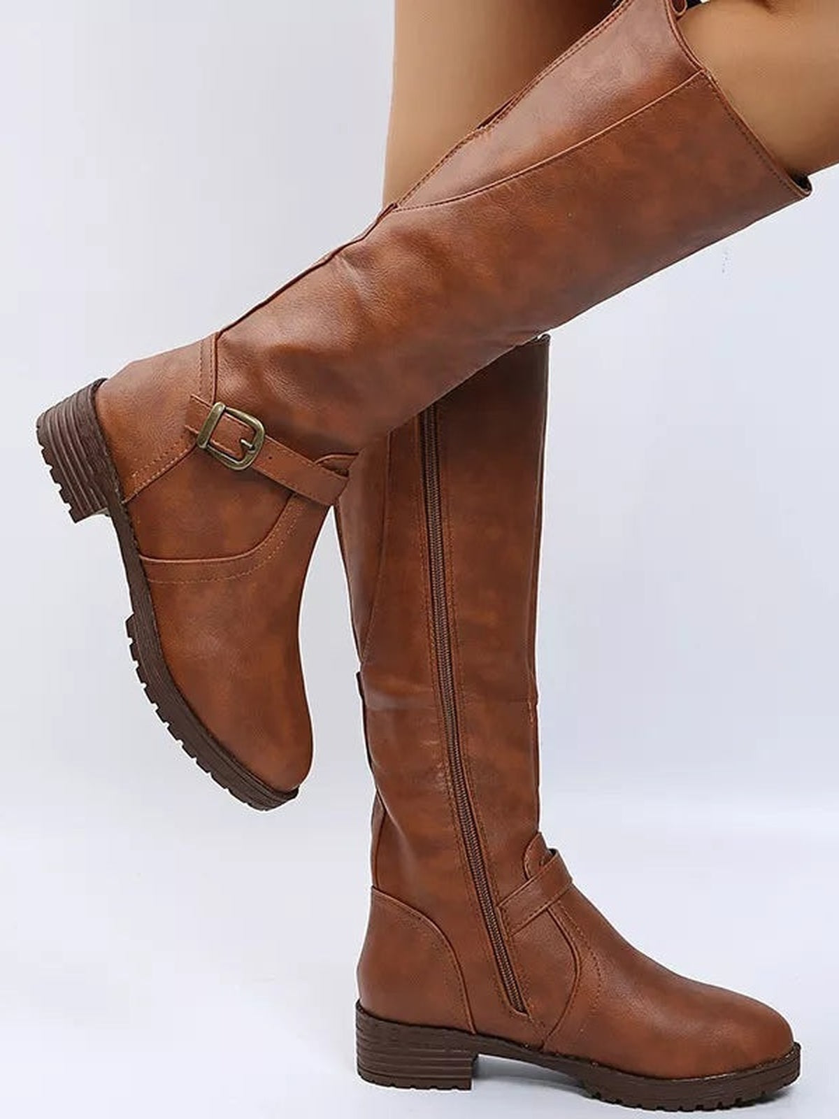 A model wears brown PU leather round-toe block heel boots with side zippers, ankle buckles, low heels, and rugged rubber soles.